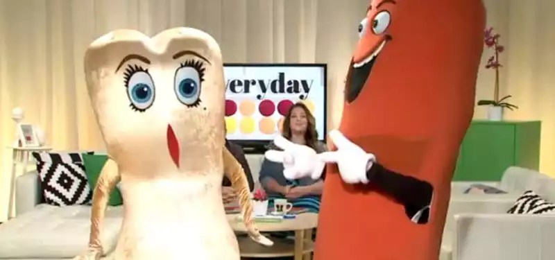 A character in a sausage party costume is doing a round of TV